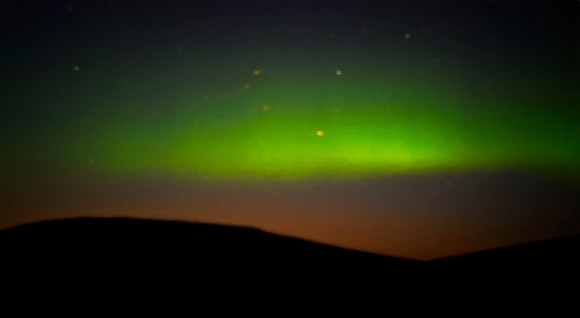 Starry blurry night and Aurora Borealis